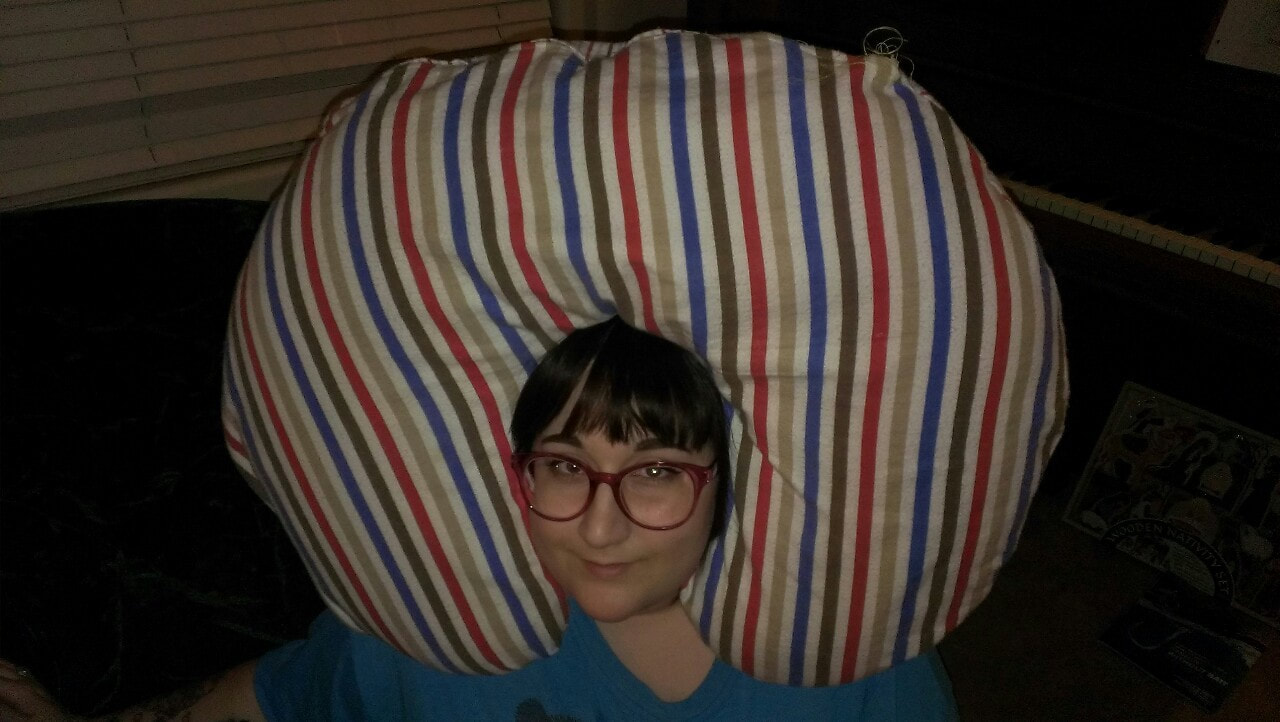 Sara with a pillow on her head